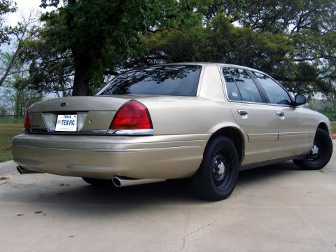2000 Ford Crown Victoria - Rear view of a gold 2000 Ford Crown Victoria sedan with a Texas license plate.