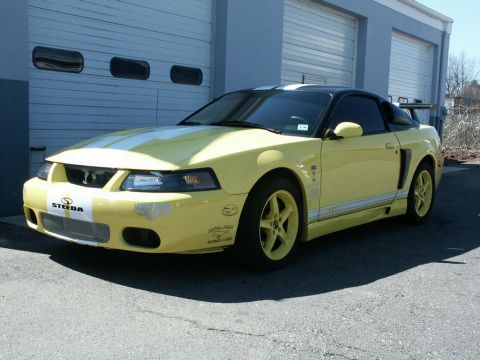2001 Mercury Grand Marquis - This yellow Ford Mustang features custom stripes and wheels, with "Steeda" branding visible on the front.