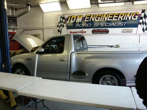 2001 Mercury Grand Marquis - A silver Ford F-150 Lightning pickup truck is on a dynamometer with its hood open, under the JDM Engineering banner.