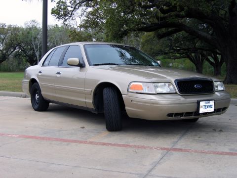 2000 Ford Crown Victoria - A gold 2000 Ford Crown Victoria is parked outdoors, showing its front-left side.