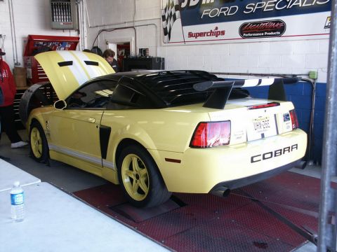 2001 Mercury Grand Marquis - A yellow 2001 Ford Mustang Cobra convertible is positioned on a dynamometer, ready for testing.