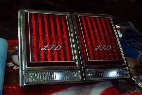 1985 Ford Crown Victoria LTD - Close-up of two red striped taillights with chrome trim and 'LTD' badging.