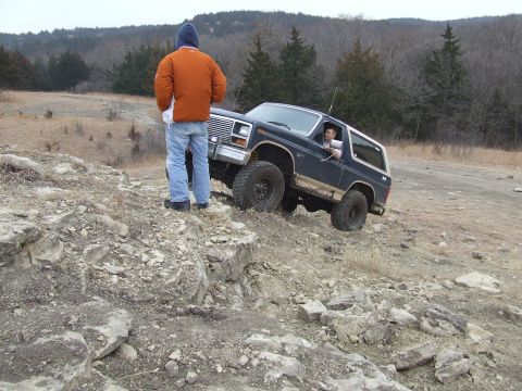 1986 Ford Bronco - A driver navigates a challenging rocky terrain in a Ford Bronco.