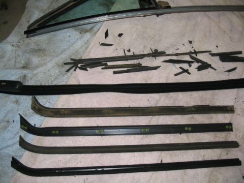1979 Ford Bronco - Various window trim pieces and degraded rubber seals are shown, likely removed for replacement.