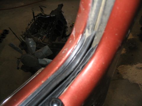 1979 Ford Bronco - Disassembled engine and car door frame detail.