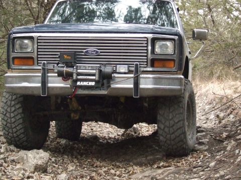 1986 Ford Bronco - This Ford Bronco is equipped with a winch and large off-road tires, suggesting it's used for terrain.