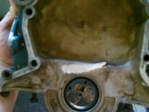 1986 Ford Bronco - This is a close-up view of a mechanical part, possibly from an engine, showing wear and sealant.