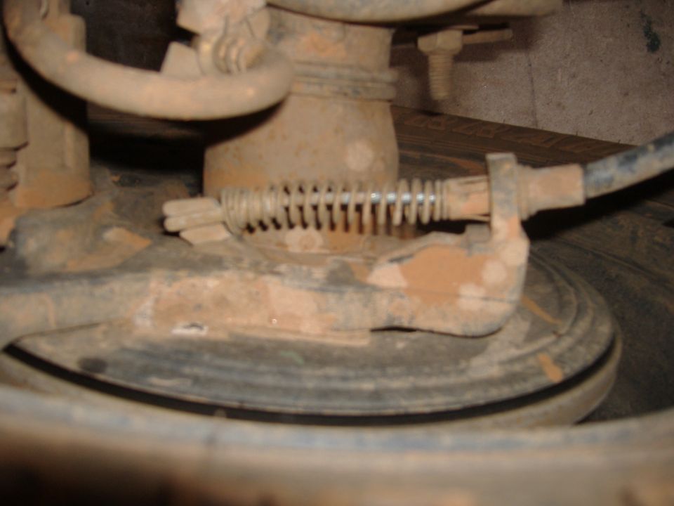 2004 Jeep Wrangler brake assembly with rusty components and a visible spring