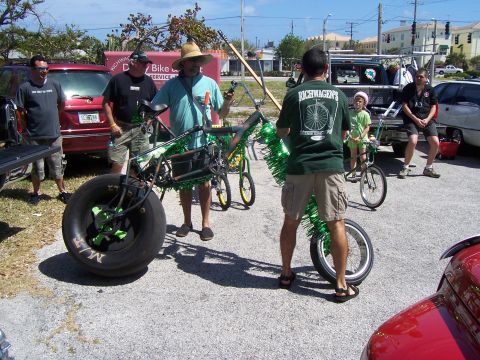1994 Ford Probe - People gather around a unique, oversized tire bicycle at an outdoor event.