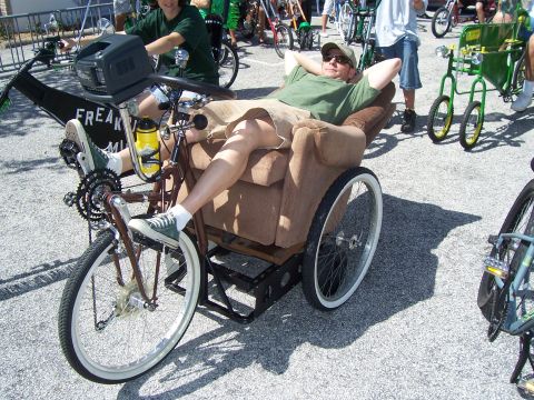 1994 Ford Probe - A unique creation a recliner chair integrated into a bicycle frame, seen at an outdoor gathering.