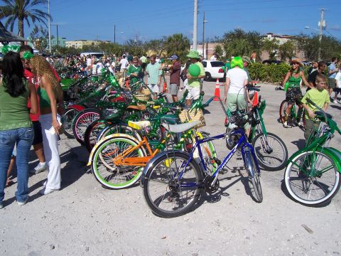 1994 Ford Probe - A crowd of people and decorated bicycles are gathered outdoors on a sunny day.