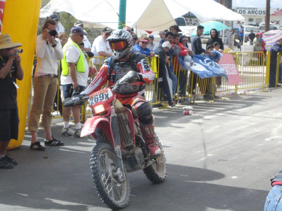 Dirt bike racer number 269x on a red off-road motorcycle
