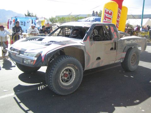 Silver and black RealTech off-road race truck on pavement