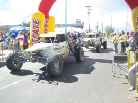Two open tube-frame off-road race buggies on the course