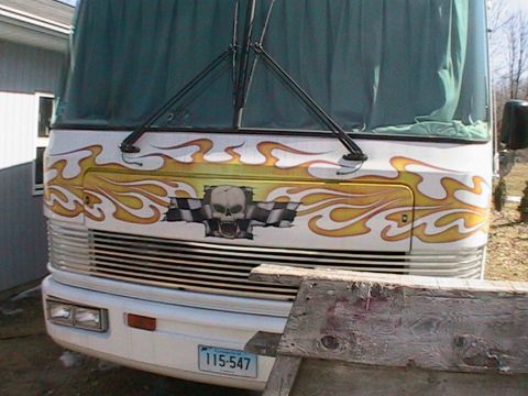 1977 Ford F-250 - This RV's front end is decorated with flames, a skull, and checkered flags.