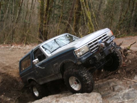 1987 Ford Bronco - This 1987 Ford Bronco is navigating a challenging off-road trail.