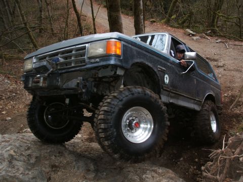 1987 Ford Bronco - This 1987 Ford Bronco is navigating a rocky off-road course with a driver behind the wheel.