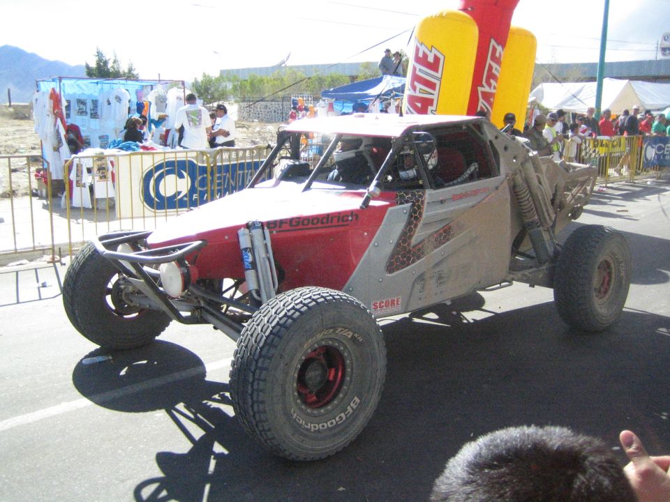 Red and silver off-road race buggy with BFGoodrich tires on pavement
