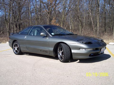 1995 Ford Probe - A gray 1995 Ford Probe coupe is parked outdoors with a wooded background and a timestamp of 03/19/2006.