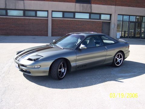 1995 Ford Probe - This 1995 Ford Probe GTS features a two-tone paint scheme with black racing stripes and custom wheels.