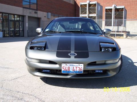 1995 Ford Probe - Front view of a 1995 Ford Probe with dual racing stripes and aftermarket blue fog lights.