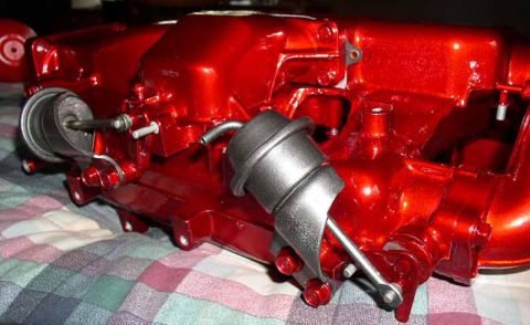 1996 Ford Probe - Red intake manifold with two actuators, close-up view. The registry label may be incorrect.