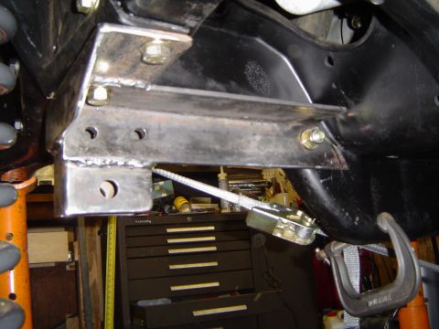 1989 Ford Bronco - Close-up view of a custom bracket being installed on a vehicle's frame, likely for an axle modification.