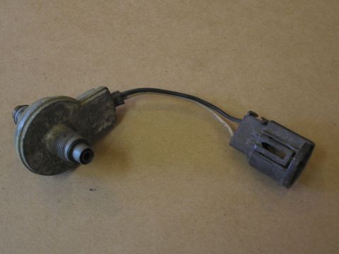 1966 Ford Bronco - This image shows an electrical sensor with its attached wire and connector, likely a component for a vehicle's electrical system.