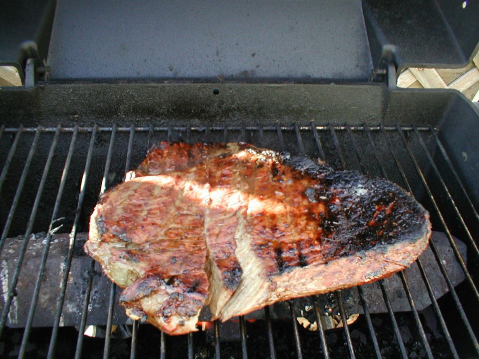 Steak cooking on a barbecue grill