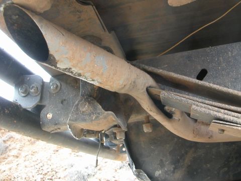 1984 Ford Bronco - Undercarriage detail of a 1984 Ford Bronco, highlighting its suspension and exhaust system.