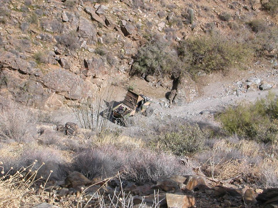 Wrecked vehicle in arid landscape