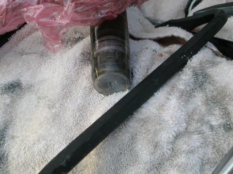 1984 Ford Bronco - A vehicle part is shown on a towel with a tool nearby, no year or vehicle identification is visible.