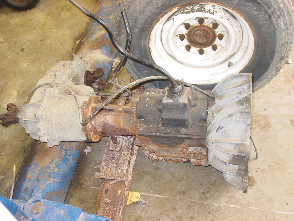 Vehicle transmission and differential assembly with a tire and wheel in the background