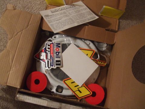 1995 Ford Probe - A clutch assembly is shown inside a cardboard box, adorned with Mobil 1 and other racing-themed stickers.