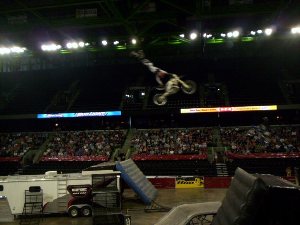 Motocross rider mid-air jump over stadium crowd
