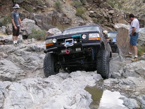 1993 Ford Bronco - Modified 1993 Ford Bronco tackling a difficult rocky off-road course.