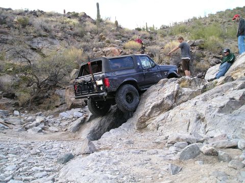 1993 Ford Bronco - A 1993 Ford Bronco tackles a challenging off-road course, demonstrating its capabilities on a steep, rocky incline.