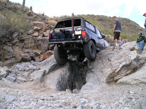 1993 Ford Bronco - Ford Bronco tackling a difficult rocky terrain during an off-road excursion.
