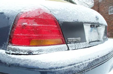1998 Ford Crown Victoria - A 1998 Ford Crown Victoria Police Interceptor is covered in ice and icicles, showing its rear end.