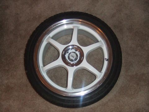 1995 Ford Probe - A single white 6-spoke alloy wheel with a polished lip is shown with a black tire.