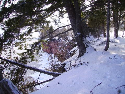 2000 Chevrolet Tahoe - A winter scene with snow-covered ground and trees, overlooking a frozen body of water.