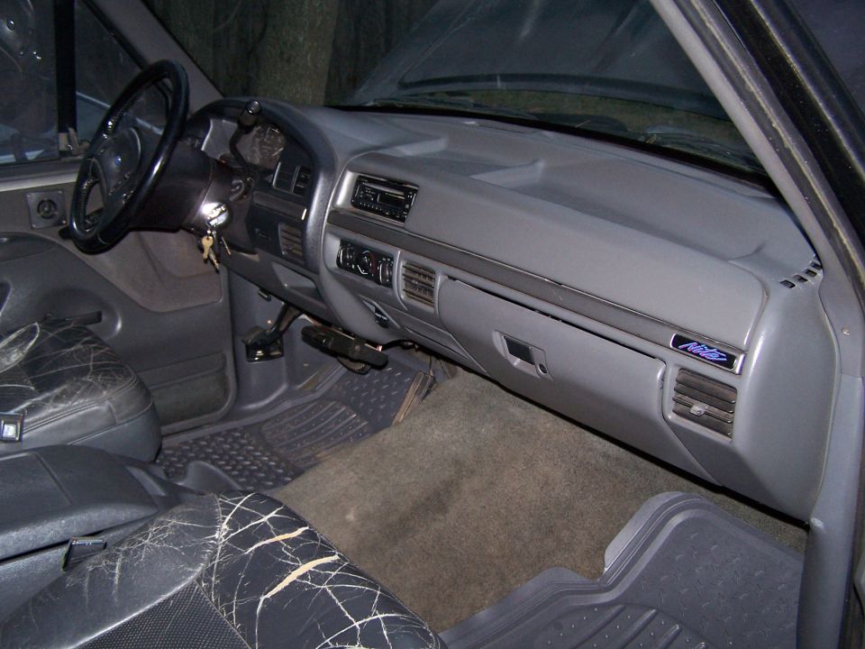 1992 Ford Bronco interior with cracked leather seats and dashboard