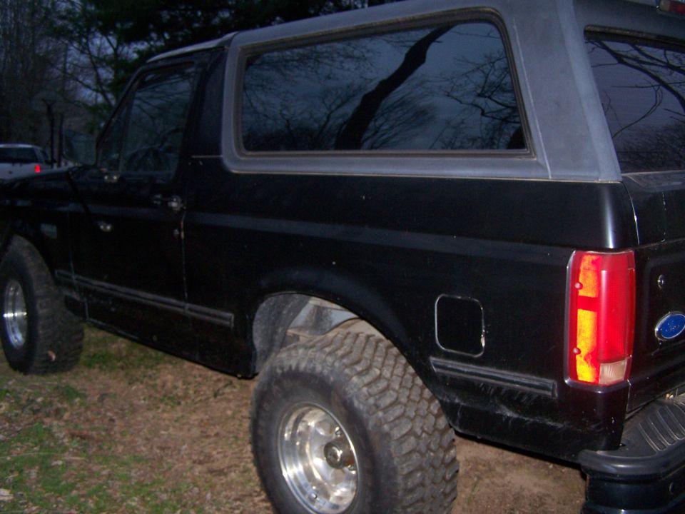 1992 Ford Bronco side view, black exterior, aftermarket wheels
