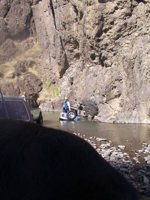 1978 Ford Bronco - Off-road vehicles navigate a river crossing in a rocky canyon.