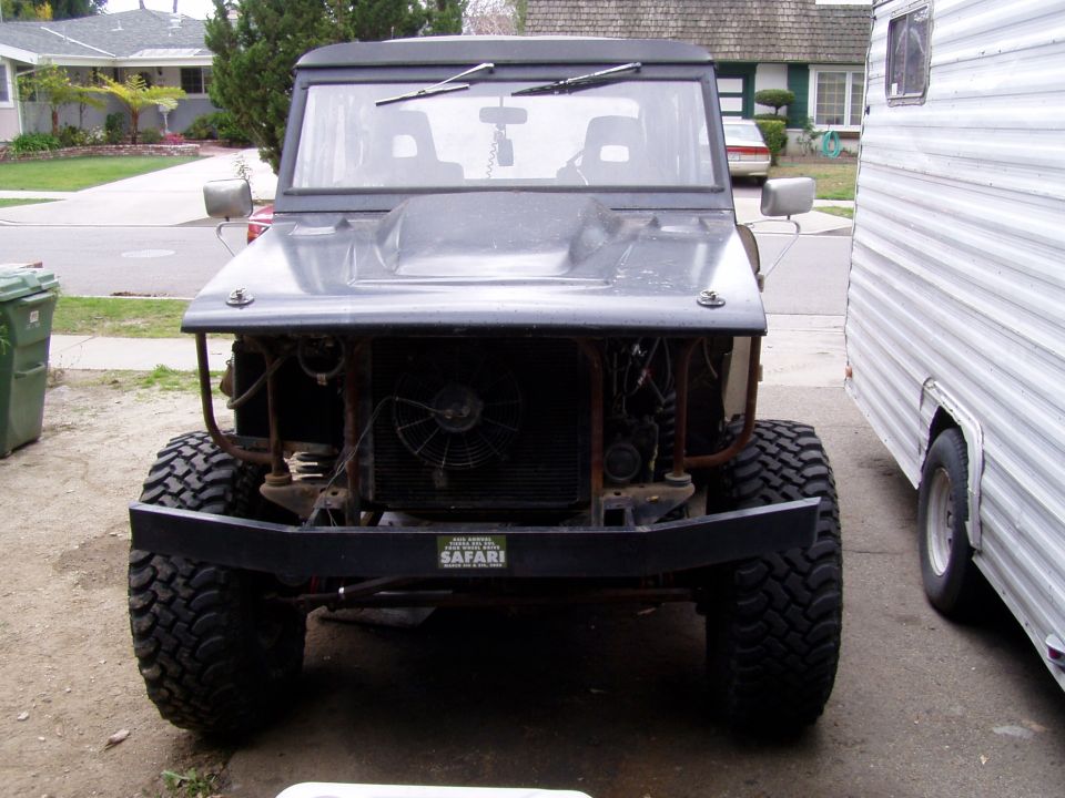 Front end without fenders/grill. Hood/radiator supported by the old temporary supports