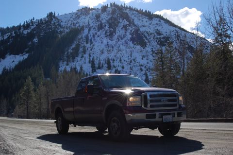 2006 Ford F-250 - Ford F-250 Super Duty pickup truck on a dirt road with a snow-covered mountain behind it.