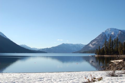 2001 Ford Taurus - A mountain lake scene with snow on the shore and snow-capped peaks in the distance.