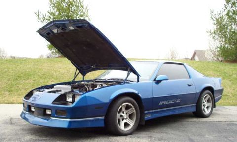 1990 Chevrolet Camaro - This blue 1990 Chevrolet Camaro IROC-Z is shown with its hood open, revealing the engine compartment.