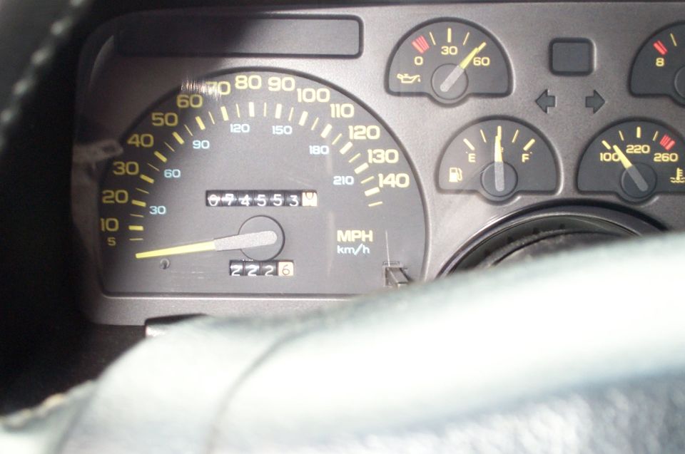 1990 Chevrolet Camaro dashboard gauges with odometer reading 69455.3