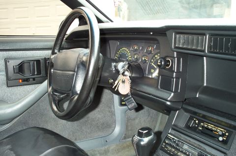 1990 Chevrolet Camaro - The interior of a 1990 Chevrolet Camaro is shown, the steering wheel, instrument cluster, and radio.